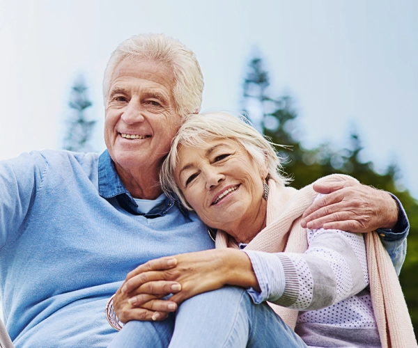 Fröhliches Senioren-Paar mit modernen Hörgeräten von Krück